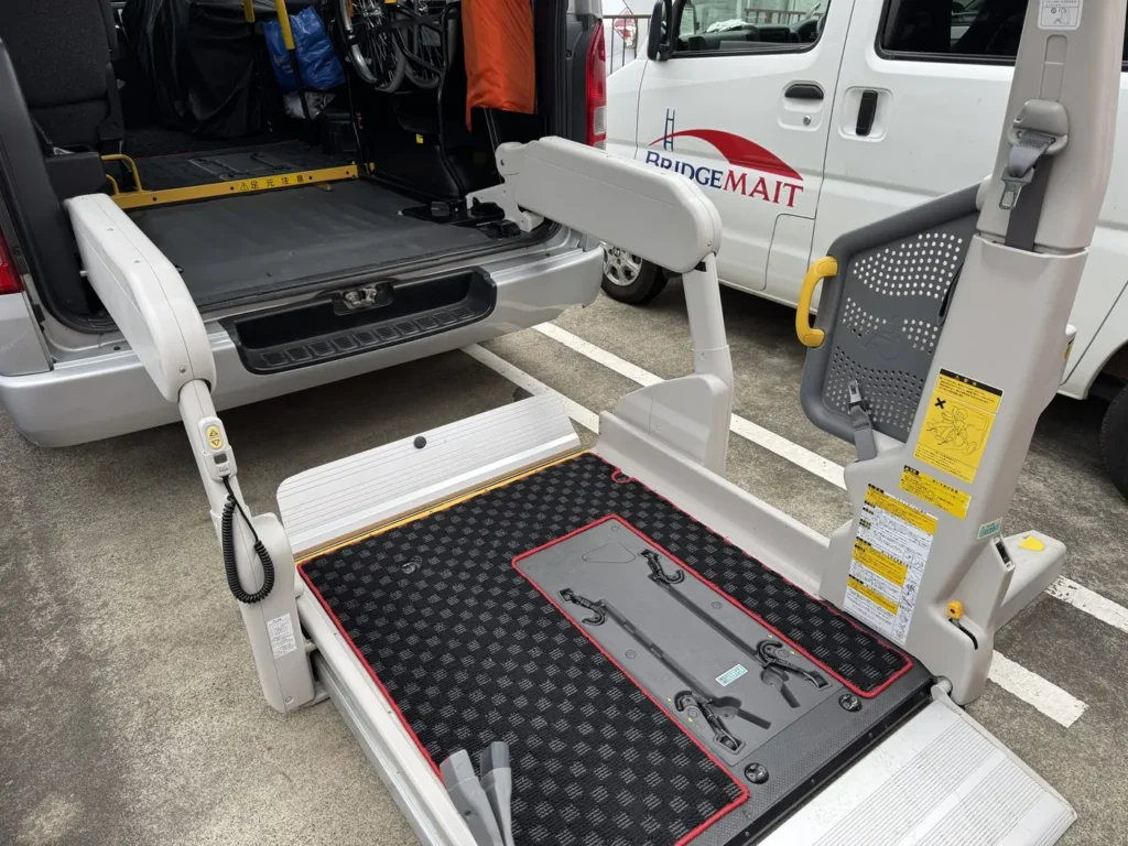 Wheelchair securement devices with retractable hooks built into the floor